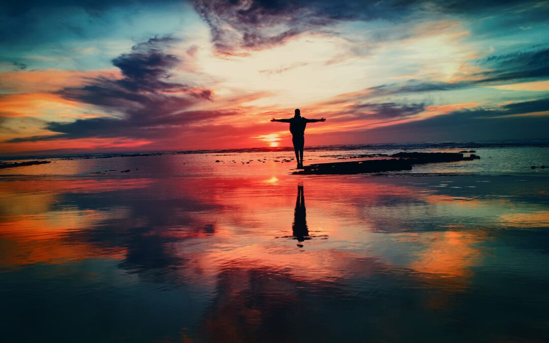 Picture of person on beach with arms outstretched
